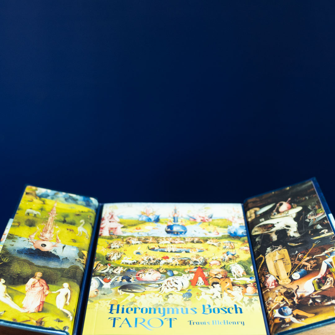 Three tarot cards from the Hieronymus Bosch Tarot set on a dark blue background.