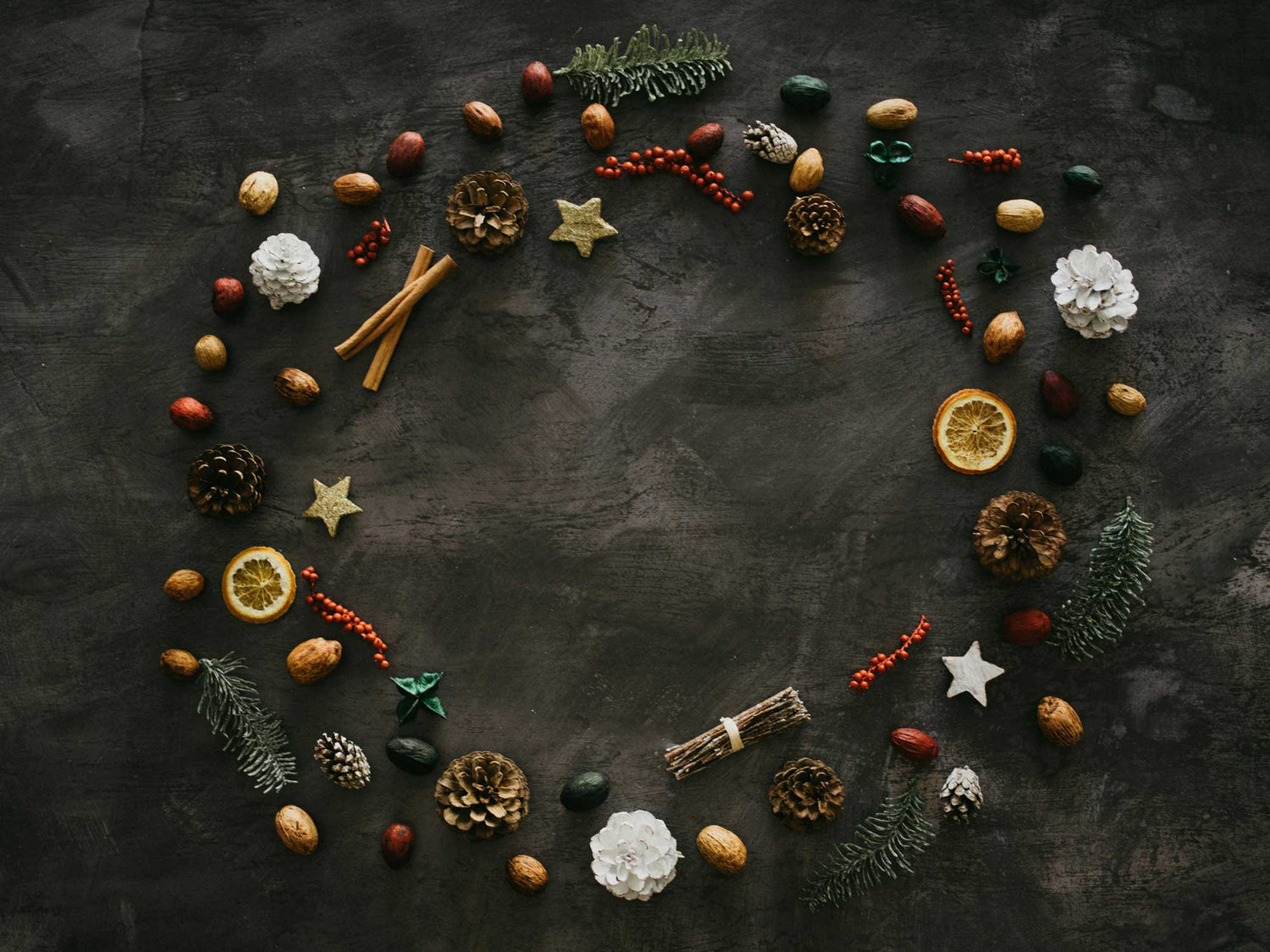 Seasonal arrangement of ornaments on a grey surface