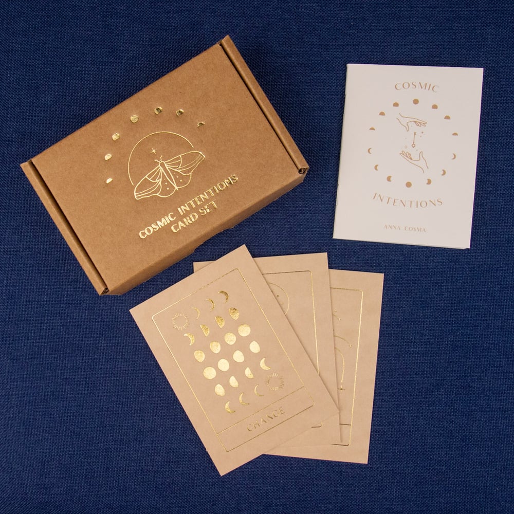 Cosmic Intentions card set with brown box and cards on a blue background