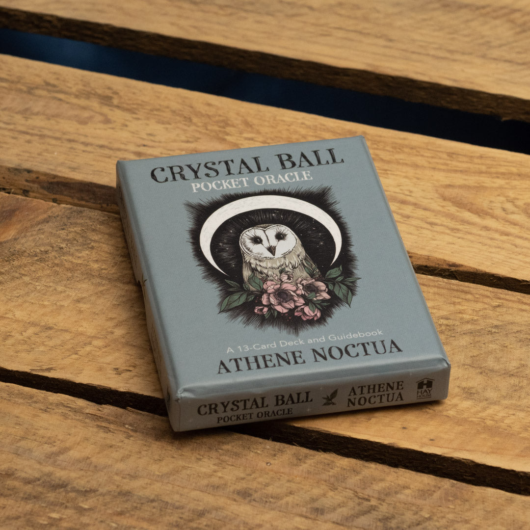 Crystal Ball Pocket Oracle deck with owl illustration on a wooden surface