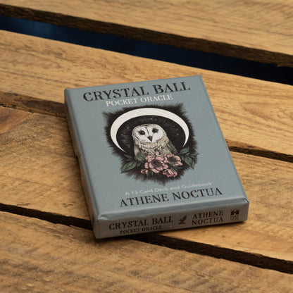 Crystal Ball Pocket Oracle deck with owl illustration on a wooden surface
