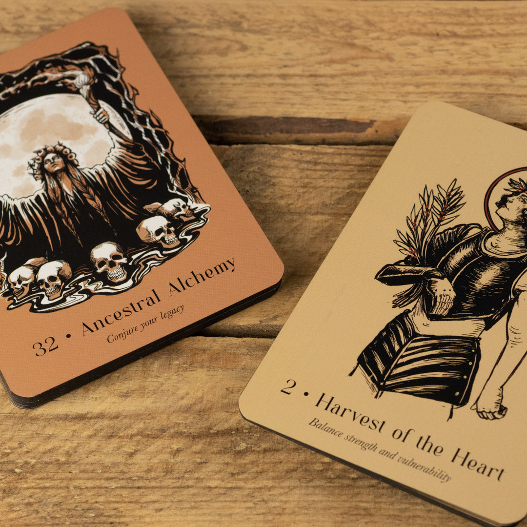 Two tarot cards from Lost Oracle Card Deck on a wooden surface, featuring intricate designs and text.