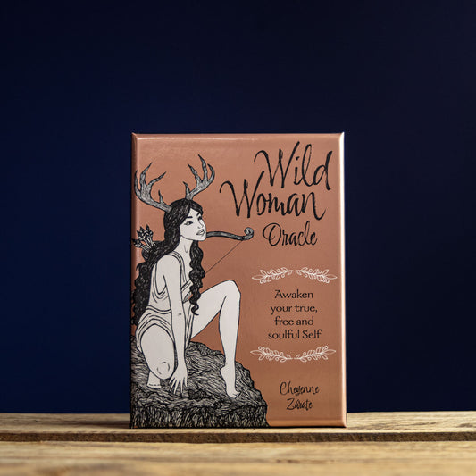 Book titled 'Wild Woman Oracle' with a illustration of a woman with antlers on a dark blue background.