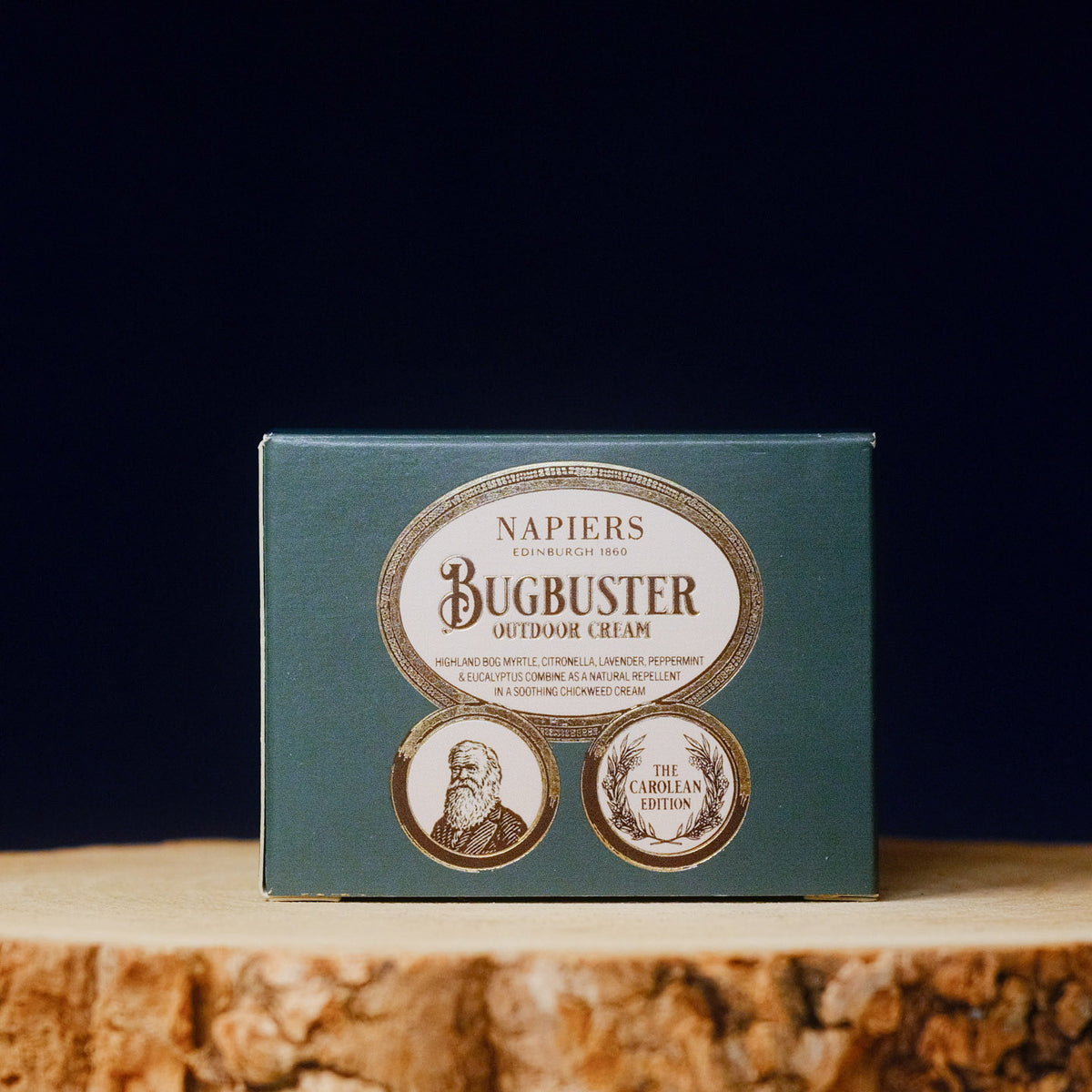 Napiers Bugbuster outdoor cream packaging on a wooden surface with a dark background