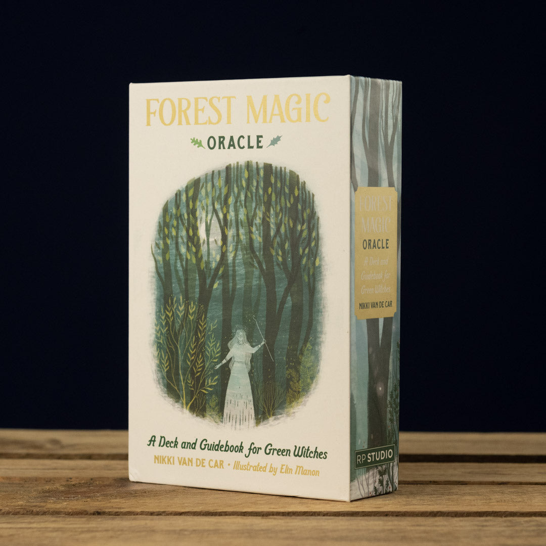 Box for 'Forest Magic Oracle' on a wooden surface with a dark background