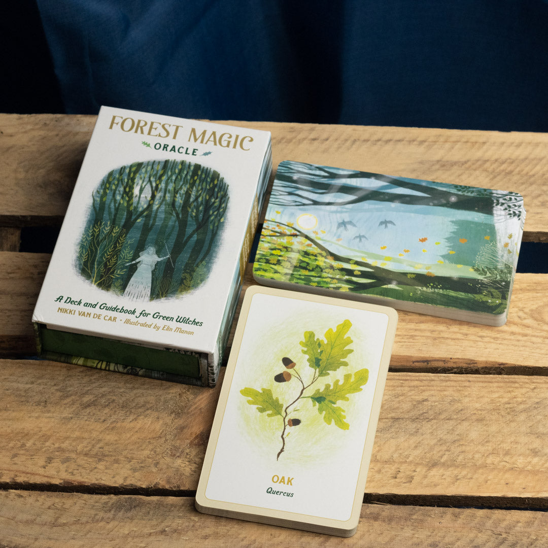 Forest Magic Oracle cards on a wooden surface with a dark background