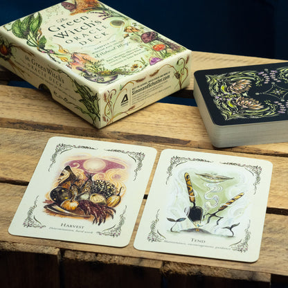 Green Witch's Oracle Deck packaging and cards on a wooden surface