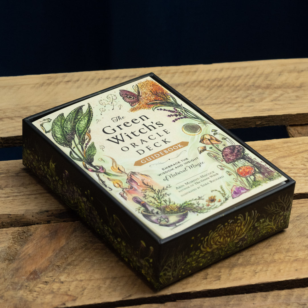 The Green Witch's Oracle Deck on a wooden surface