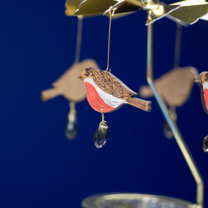 Decorative bird ornament with red breast on a blue background