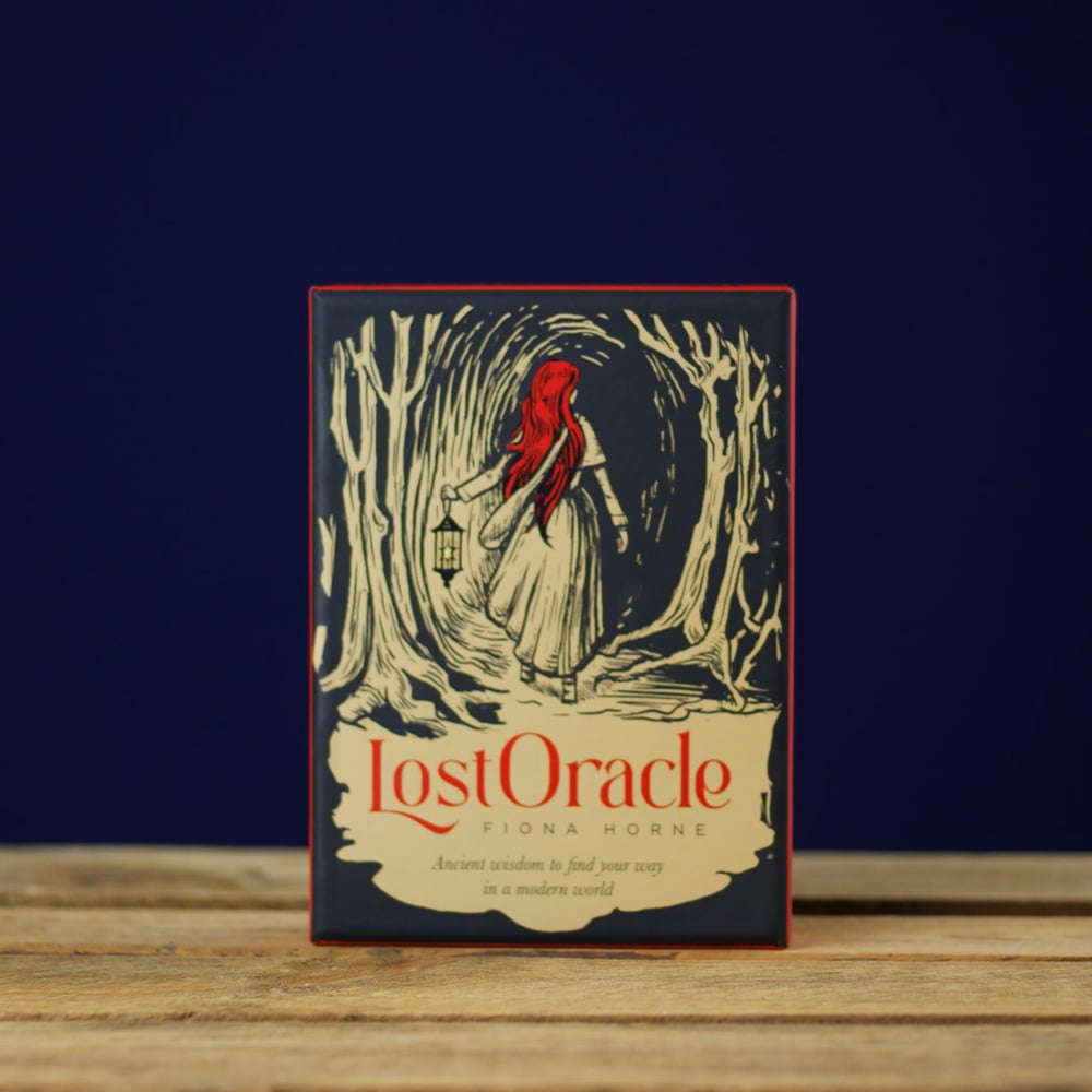 'Lost Oracle' Card Set by Fiona Horne on a wooden surface with a dark blue background