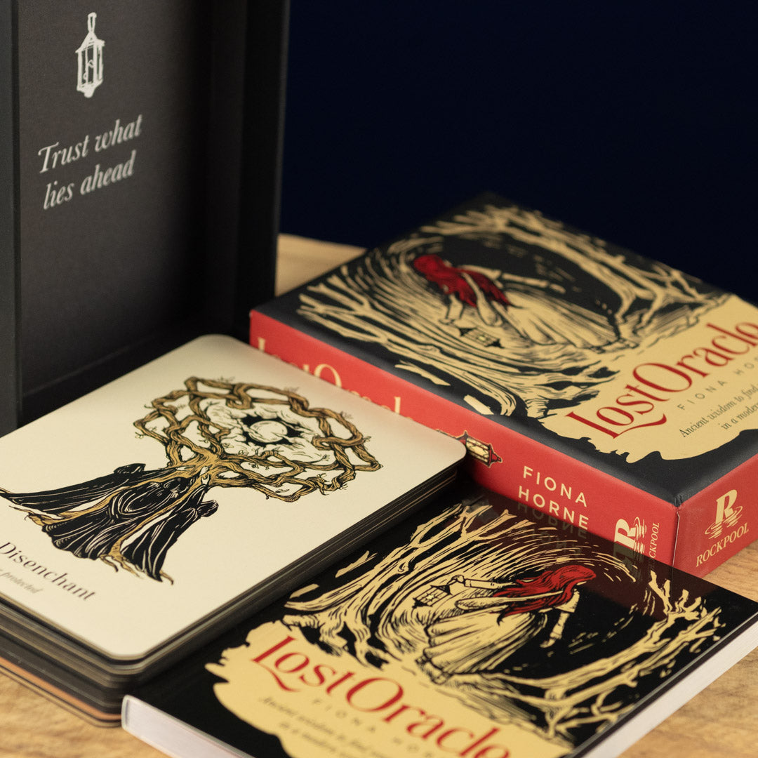 'Lost Oracle' by Fiona Horne on a wooden surface with a dark background.