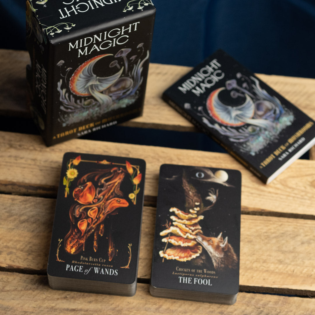 Midnight Magic tarot cards on a wooden surface with packaging.