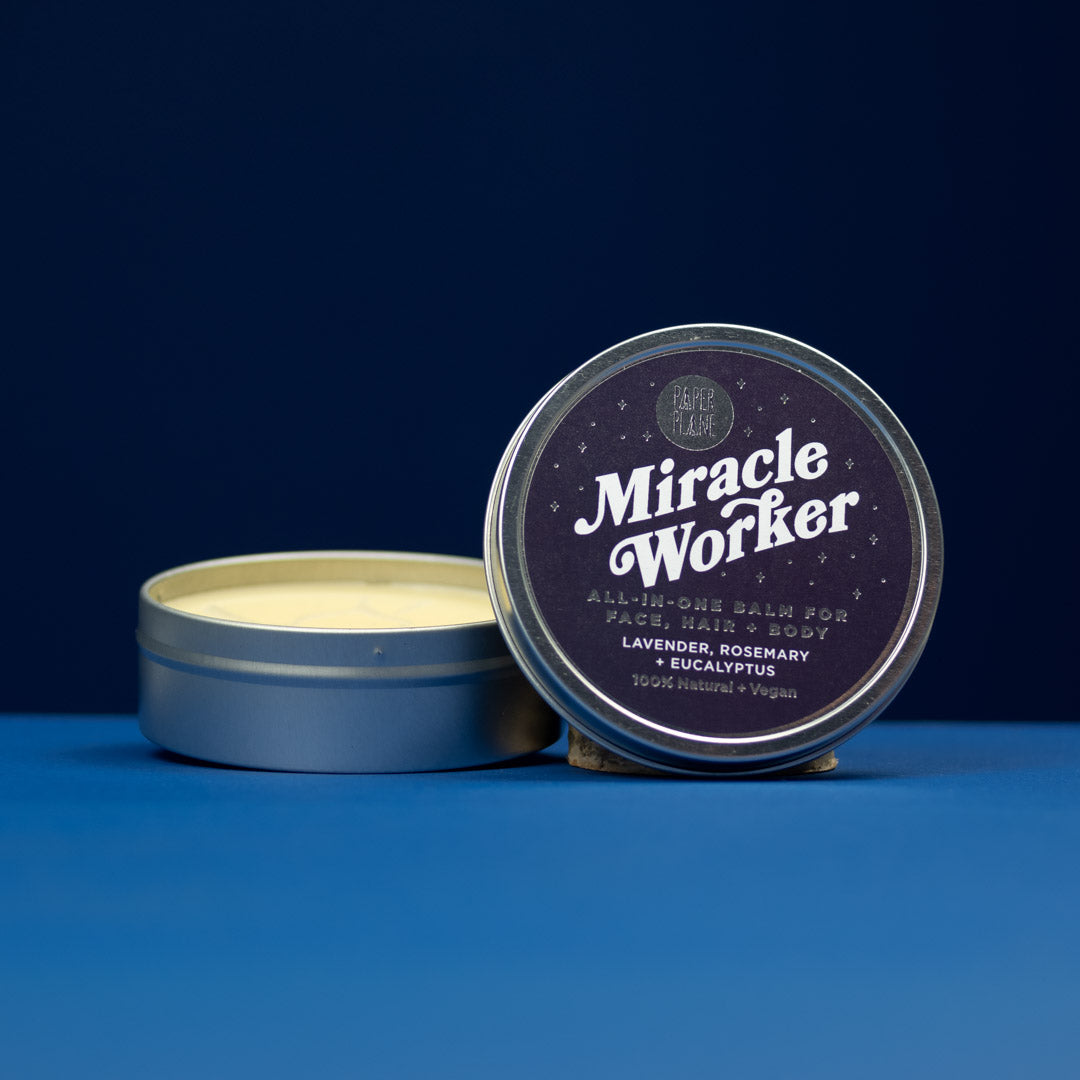 Tin of 'Miracle Worker' balm with a blue background