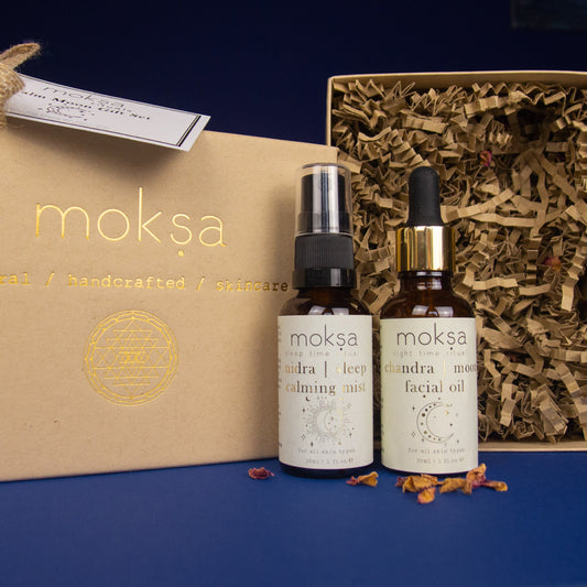 Two moksa skincare bottles with a branded box on a blue background