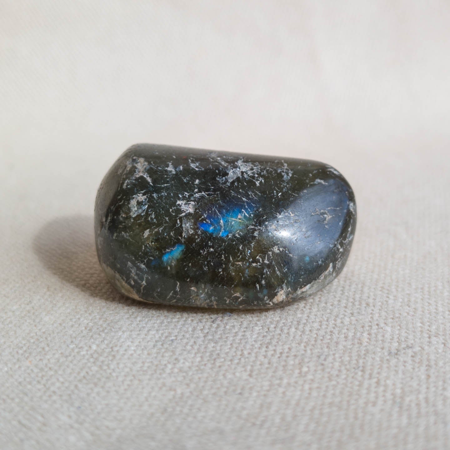 polished moss agate crystal on fabric background