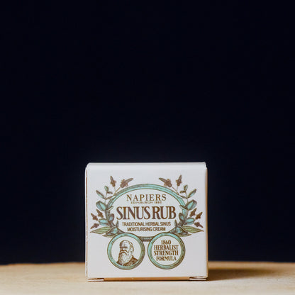 Napier's Sinus Rub cream packaging on a wooden surface with a black background