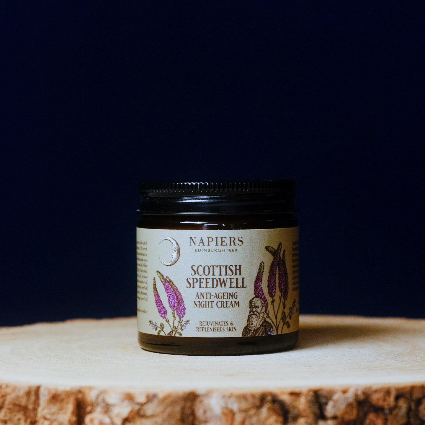 Jar of Napiers Scottish Speedwell Anti-Ageing Night Cream on a wooden surface with a dark background
