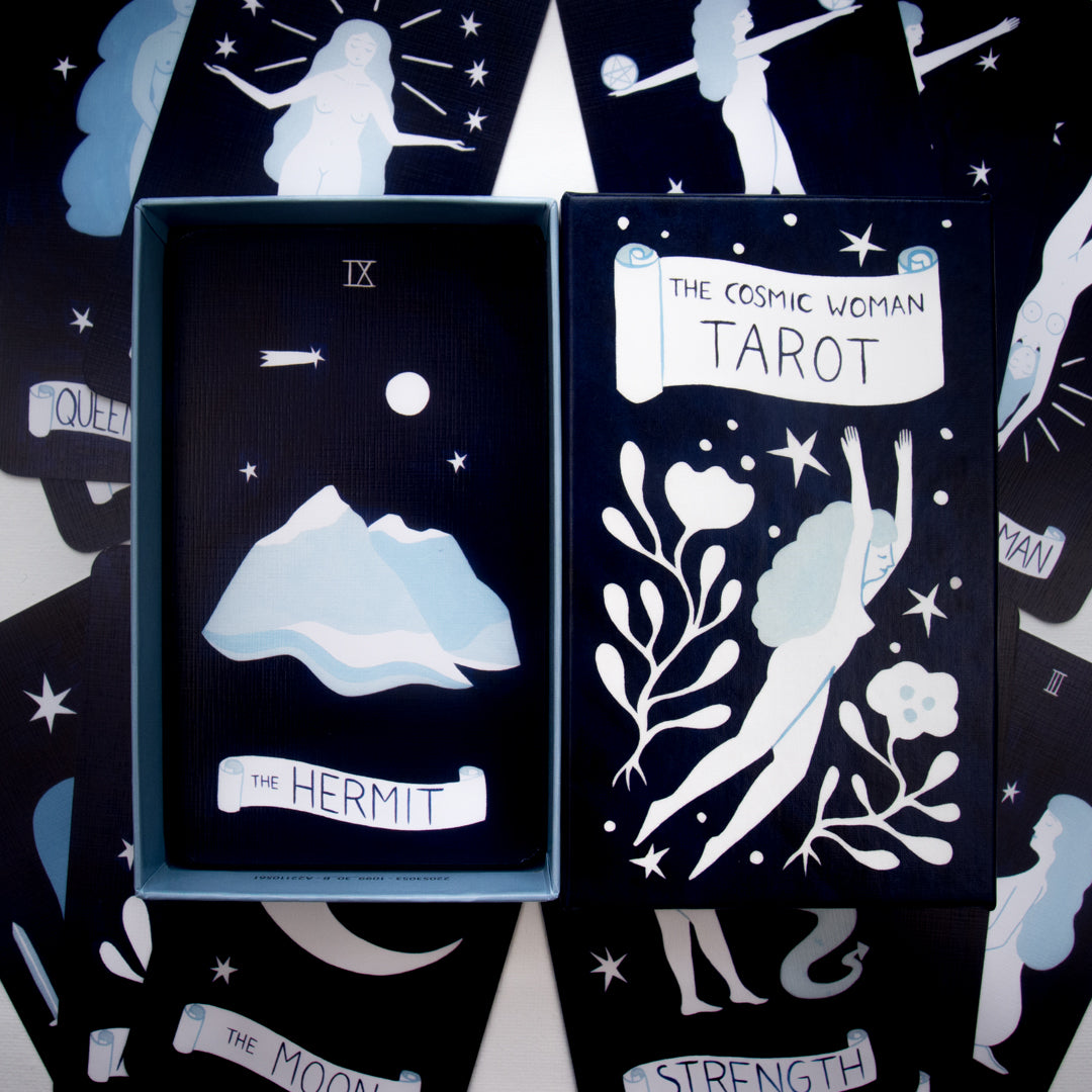 Tarot card set with 'The Hermit' card and 'The Cosmic Woman Tarot' packaging.
