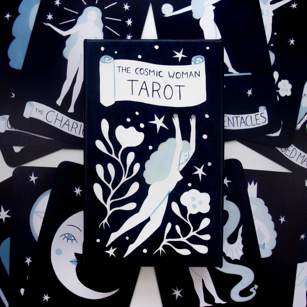 Tarot card deck with 'The Cosmic Woman Tarot' on a black background with white illustrations.
